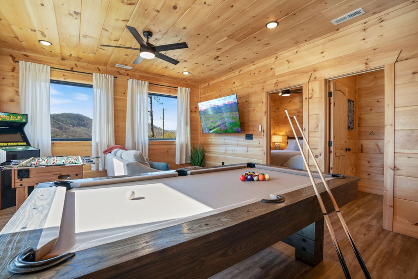 Game room with pool table, foosball, arcade, and mountain views