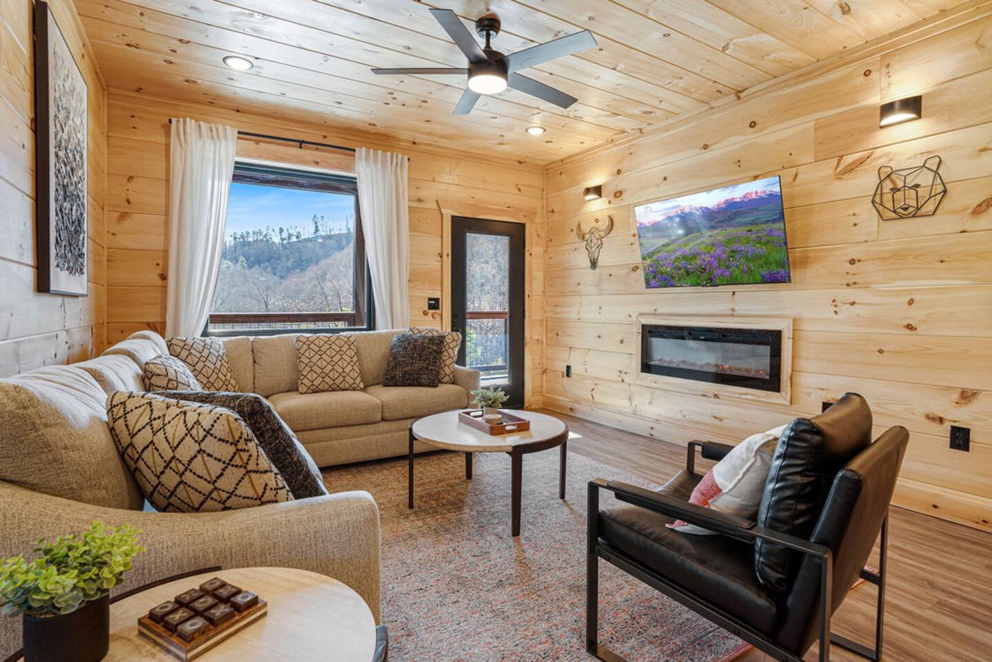 Living room with sectional, fireplace, and mountain view window